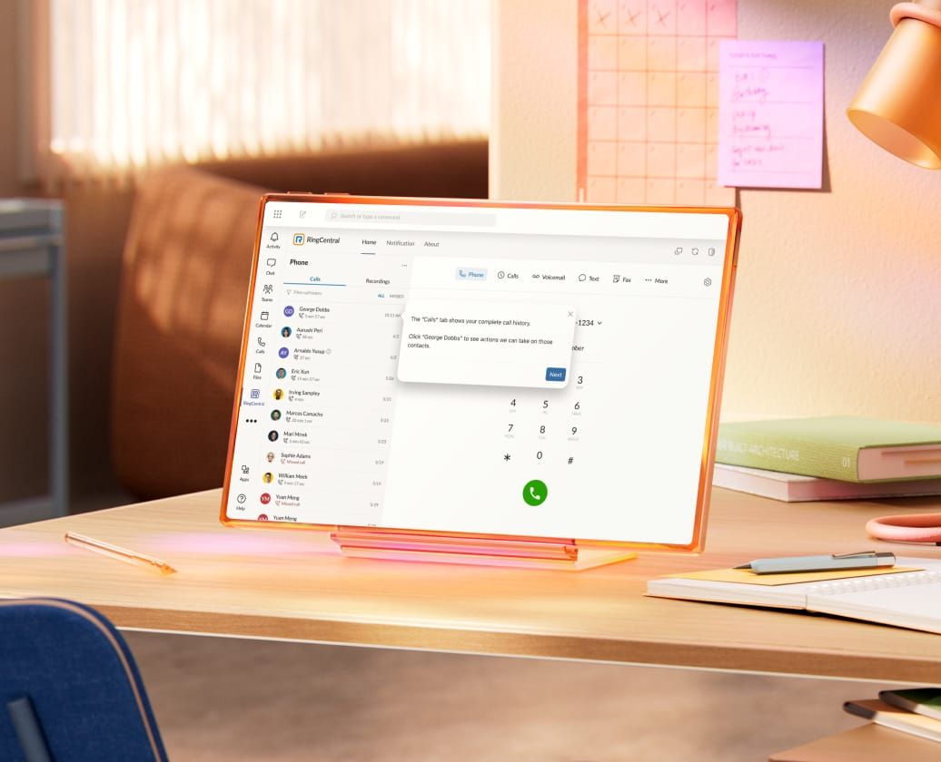A laptop on a wooden desk beside a desk lamp, creating a cozy workspace environment.