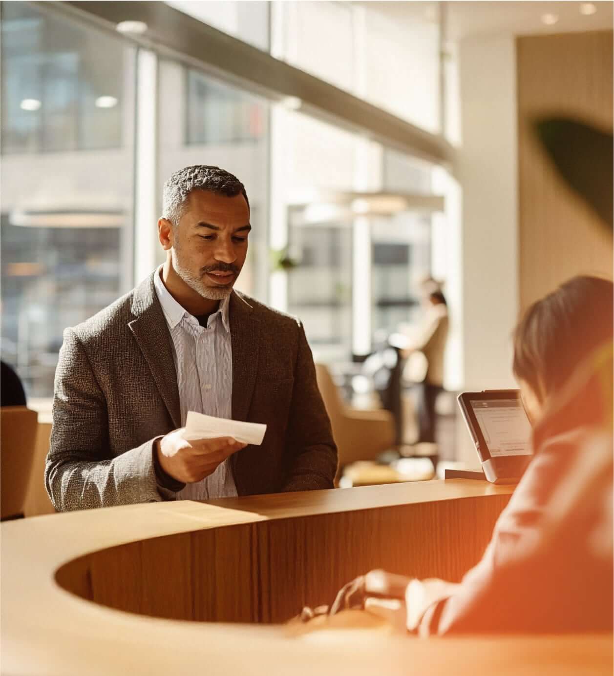 A male customer talking to a female receptionist