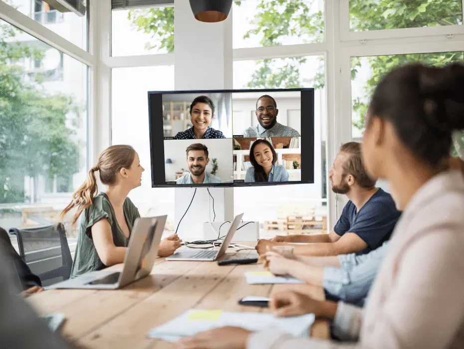 Team in a video meeting with their remote coworkers